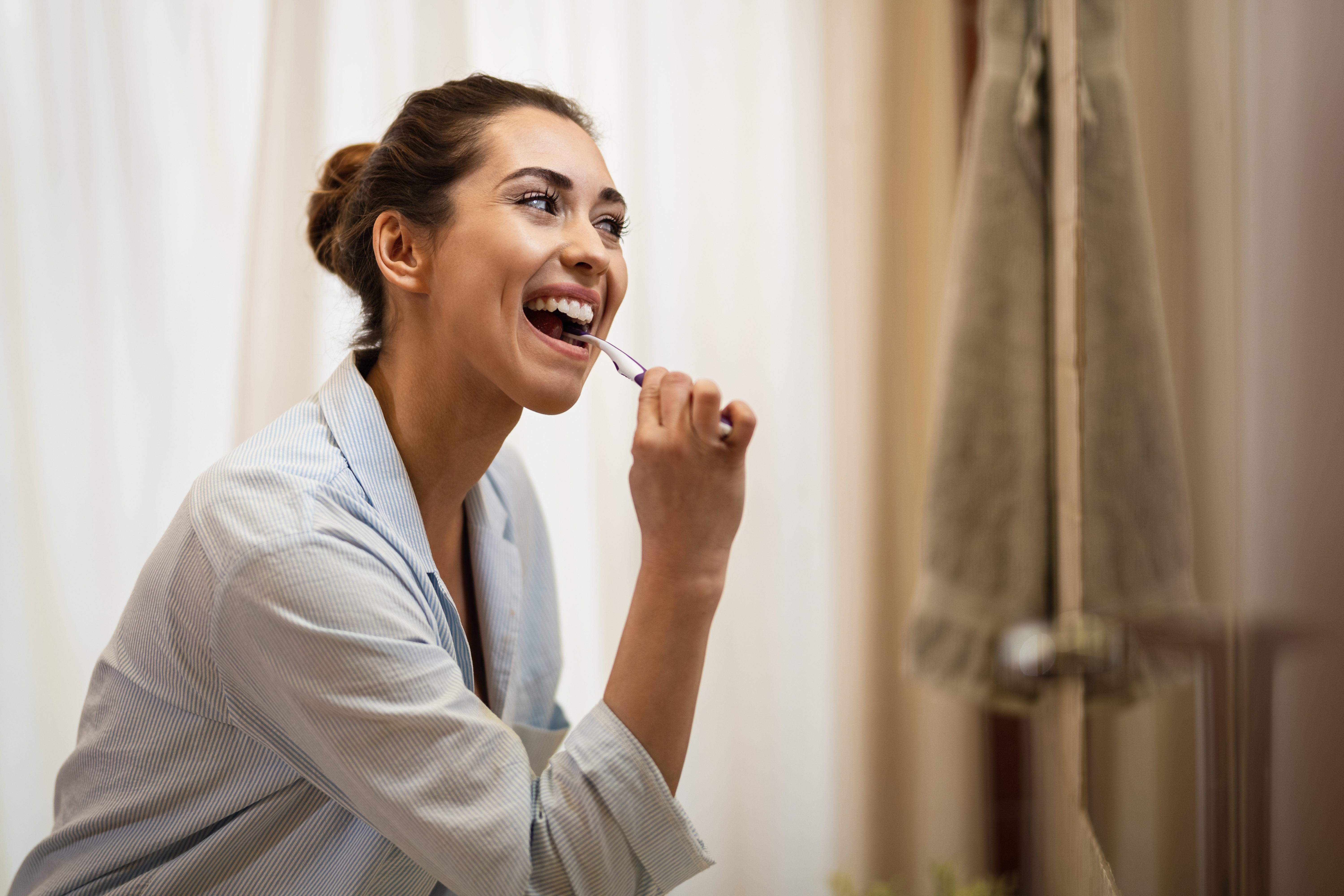 Person brushing to care for their dental implant