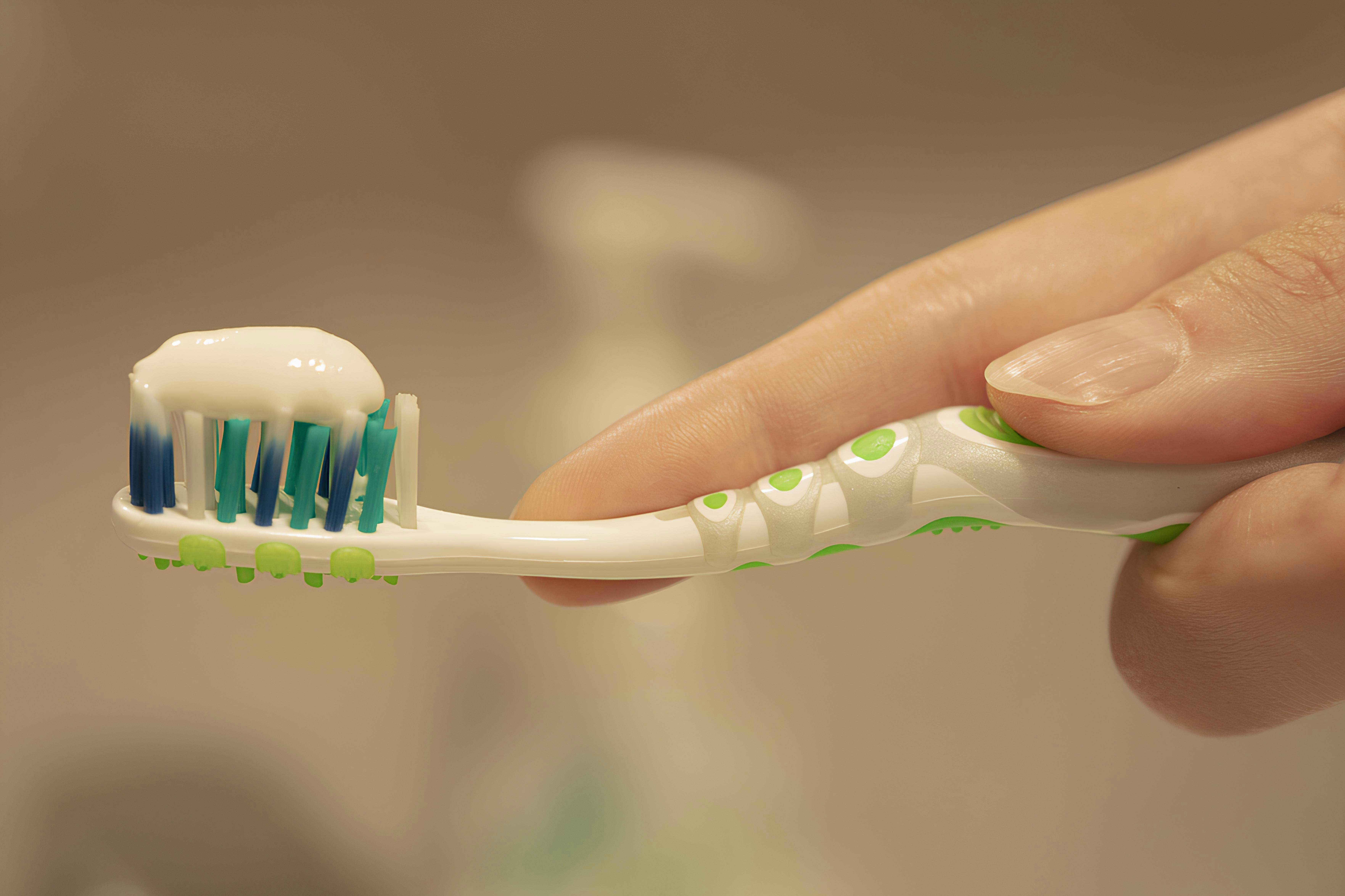Person caring for their teeth after a root canal
